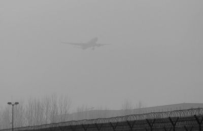 在首都機(jī)場(chǎng)，飛機(jī)在霧霾中降落。