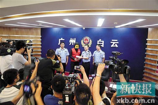 因舉報涉毒案件線索而獲獎的“快遞小哥”戴著面具領取獎金。