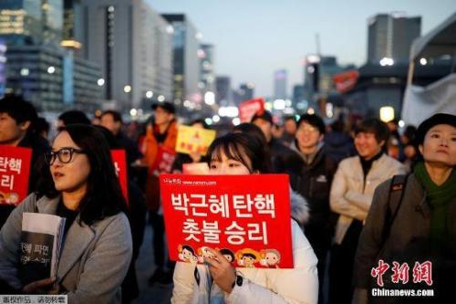 資料圖：當(dāng)?shù)貢r間3月10日上午，韓國憲法法院就總統(tǒng)彈劾案審判，樸槿惠被立即免去總統(tǒng)職務(wù)。當(dāng)晚，韓國民眾走上首爾街頭舉行燭光集會。
